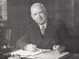 Mr Allon Dawson at a Desk with Pen - Taken from OUR DOGS Christmas Number 1955, Page 108